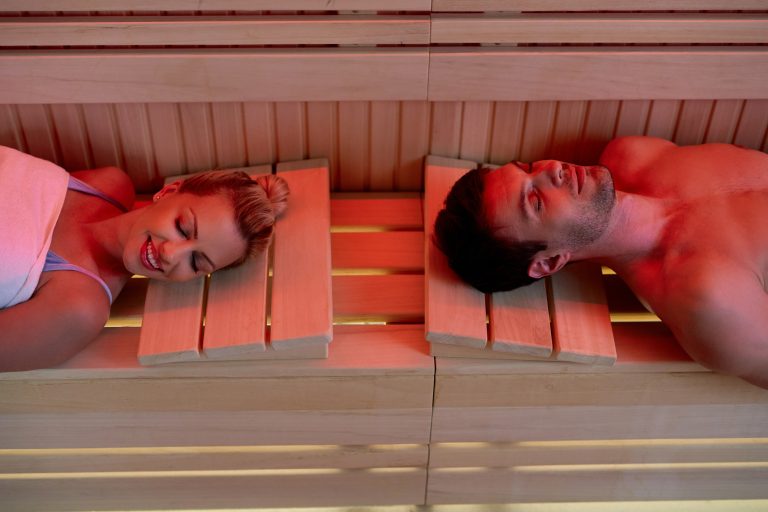 Couple relaxing in an infrared sauna